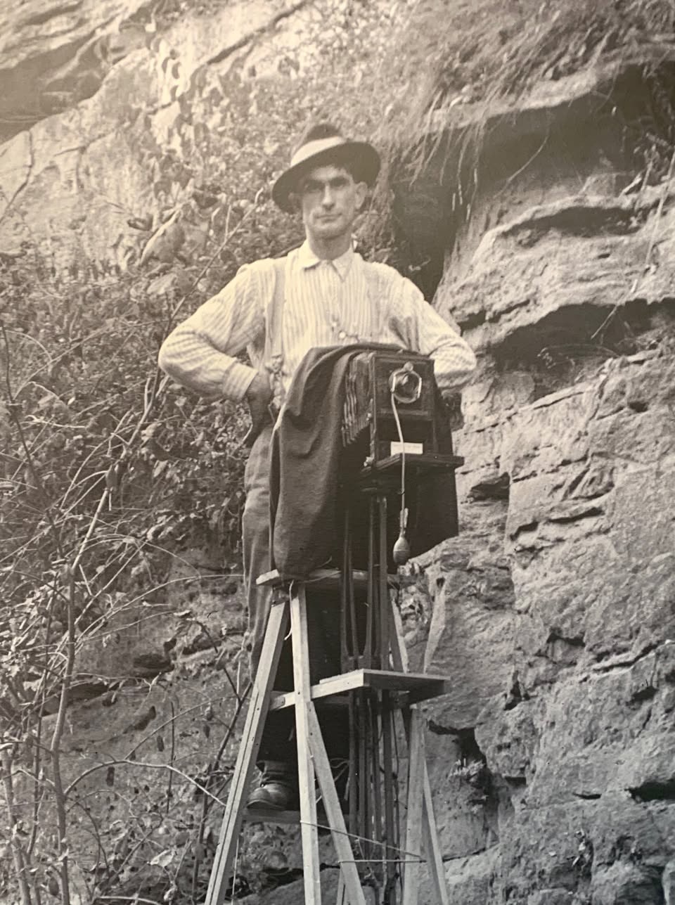 Old time photo of a photographer, John Runk of Stillwater, MN, on a ladder.